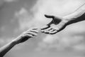 Solidarity, compassion, and charity, rescue. Hands of man and woman reaching to each other, support. Giving a helping Royalty Free Stock Photo