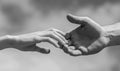 Solidarity, compassion, and charity, rescue. Lending a helping hand. Hands of man and woman reaching to each other Royalty Free Stock Photo