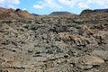 Solidified lava flow and crust with volcanic mountains on the background in Timanfaya National Park, Lanzarote, Canary Islands