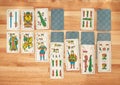 Solitaire card game with Spanish playing cards on a wooden board Royalty Free Stock Photo