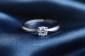 Solitaire diamond engagement ring on satin Royalty Free Stock Photo