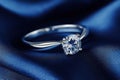 Solitaire diamond engagement ring on satin Royalty Free Stock Photo