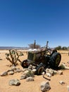 Abandoned old rusty tractor. Body of a retro car in the sands. Desert in Namibia Royalty Free Stock Photo