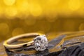 Engagement Diamond Ring on Golden Bokeh Background Royalty Free Stock Photo