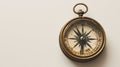 A solitary antique compass, isolated against a clean smooth single color backdrop