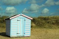 Solitary beach hut in the sand dunes.