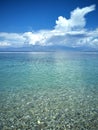 A solitary beach, with pristine sea and beautiful white clouds formations on the blue sky Royalty Free Stock Photo