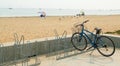 Solitary bicycle in a bike rack at an almost empty beach
