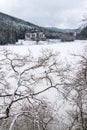 Solitary building in beautiful snowy winter forest landscape, frozen Brezova dam Royalty Free Stock Photo