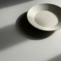 A solitary ceramic plate sits on Royalty Free Stock Photo