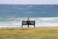 Solitary Female Sitting on Wooden Bench