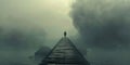 Solitary figure on a foggy pier