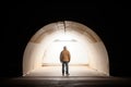 solitary figure standing at the end of a tunnel Royalty Free Stock Photo