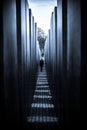 Solitary figure strides through an ancient stone colonnade in Berlin, Germany. Royalty Free Stock Photo