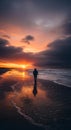 Solitary figure walking on a reflective beach at sunset with dramatic clouds and ocean waves nearby Royalty Free Stock Photo