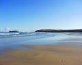 Solitary footprints cross the fresh sand towards the lighthouse at Godrevy near St Ives Cornwall