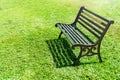 Solitary green iron bench in the garden, A bench on the green lawn in the garden Royalty Free Stock Photo