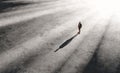 Solitary man walking in vast empty space Royalty Free Stock Photo