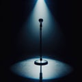 A musical instrument: microphone stand, sits on alone on stage ready to play, under a strong single spotlight