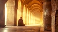 Serene monk meditation in sunlit temple corridor Royalty Free Stock Photo