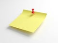 Single red pushpin securing yellow note isolated on white background Royalty Free Stock Photo