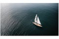 A solitary sailboat on a still lake