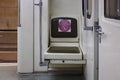 Solitary seat in Rusich subway car of Moscow metropolitan with inscription meaning KEEP THE DISTANCE DO NOT SIT DOWN HERE. Royalty Free Stock Photo