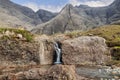 Isle of Skye Fairy Pools, embraced by craggy Cuillin grandeur, receive waters from a solitary waterfall