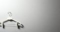 Solitary White Clothes Hanger Casting Shadow on Gradient Gray Wall Royalty Free Stock Photo
