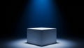 A stark white cube rests on a illuminated platform under a single blue spotlight in a dark void Royalty Free Stock Photo
