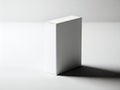 A solitary white rectangular block casting a soft shadow on a plain background Royalty Free Stock Photo