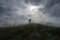 solitude concept of travel active lonely man on grass hill with cloudy sunset on background with copy space during