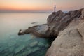 Solitude girl watching sunrise high up on cliff by sea Royalty Free Stock Photo