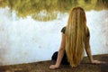 Solitude - lonely woman sitting on lake side