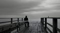Solitude on a Pier in Monochrome. Created with Generative AI