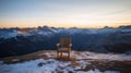 Solitude\'s Embrace: A Wooden Chair at Sunset on an Alpine Mountain Peak