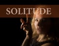 Solitude written on virtual screen. hand of young woman melancholy and sad at the window in the rain. Royalty Free Stock Photo