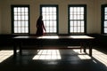 Solitude& x27;s Silhouette: The haunting silhouette of a lone woman in the bright corner of an empty room, capturing the