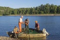 Salmon fishermen clean the net