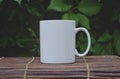 A solo blank white coffee mug on the bamboo table in the garden Royalty Free Stock Photo