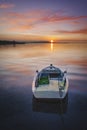 Solo boat on sunset red clouds and sun Royalty Free Stock Photo