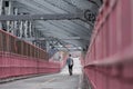 Solo casual man walking the cycling lane on Williamsburg Bridge, Brooklyn, New York City, USA Royalty Free Stock Photo