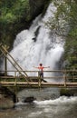 Solo female middle aged tourist are relaxing on tropical forest trail in the outdoor recreation activities