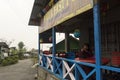 A solo female traveler sitting at a small cafe having tea and watching her camera to see what she captured earlier