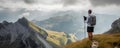 Solo hiker admiring the view on top of a mountain. French Alps view of the Col des Aravis - tourism and vacation - Pointe de