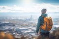 solo hiker overlooking a city from a hilltop