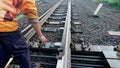 SOLO, INDONESIA - MARCH 01 2020 : Check the connection and railroad bolts manually by the worker Royalty Free Stock Photo