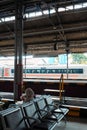 A woman sits waiting for a train at the solo train station Royalty Free Stock Photo