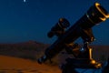 solo observer with a telescope lens focused on a celestial event, desert night