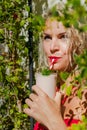 Solo outdoor activities. Portrait of blond woman in red swim suit holding a cup of smoothie. Royalty Free Stock Photo
